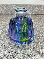 Front view of faceted iridescent glass vase