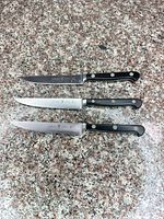 Three knives laid side by side showing full length and handles