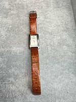 Full view of Kenneth Cole rectangular watch with brown leather strap