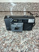 Front view showing lens cover open, lens, flash, and VR35/K500 markings