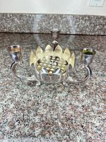 Front view showing lotus bowl, flower frog insert, three candle arms