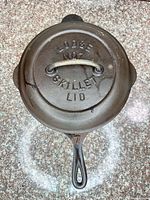 Top view of skillet with lid showing embossed lettering and handle