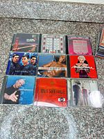 All nine CD fronts displayed on countertop