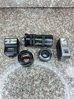 Full lot showing both lenses, two flashes, adapter and filters