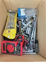 Box overview showing multimeter, sockets, extensions, screwdrivers