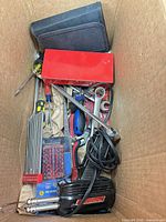 overview of tools in box showing soldering iron, screwdrivers, bit set, wrenches, hex keys and pouch