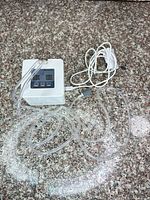 Top view of control unit with attached tubing and USB cable
