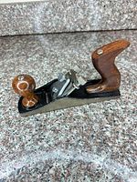 Full side view of plane showing body, blade, knob, tote