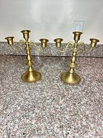 Both brass candelabras side by side showing overall form