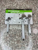 Front view of sealed blister card showing three Pittsburgh adjustable wrenches