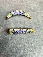 Front view of both brooches showing porcelain floral design