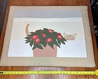 Full view of quilted wall hanging with measuring tape showing width