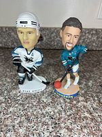 Front view of both Ricci and Thompson bobbleheads