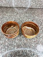 Both stoneware bowls side by side showing interiors and glaze