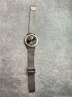 Full view of Sharper Image wristwatch with mesh band