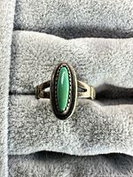 Front view of sterling silver ring with green turquoise cabochon