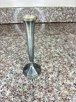 Full view of silver-plated bud vase on granite counter