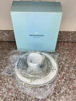 Wedgwood branded box with wrapped place setting pieces
