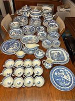 Full view of entire 153-piece Wedgwood Blue Willow dinnerware laid out on table