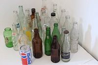 Full group of bottles and can on white background