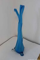 Full view of tall blue and white swung glass vase