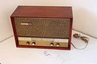 Front angled view of wooden Musaphonic radio showing cabinet, grille, dial, knobs, power cord