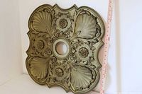 front view of entire medallion against tape measure