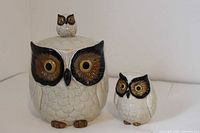 Front view of ceramic owl cookie jar and smaller owl coin bank