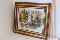 Front angled view of framed painting showing boats scene and frame