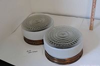 Two matching round glass ceiling fixtures side by side