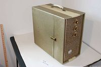 Closed record player cabinet showing exterior finish, handle and front control panel