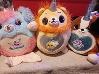 Three Hatchimals plush lined up showing size, colors, and belly patches