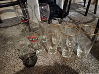 Group shot showing branded beer glasses, gold-rim glasses, tumblers
