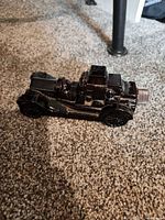 Right side view of amber glass car decanter on carpet