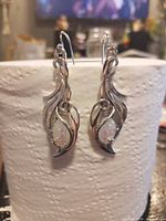 Front view of earrings hanging to show overall design and cabochon stones