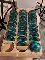 Tray with rows of green glass tealight holders