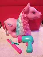 large pink pony with styling accessories