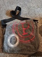 Front view showing flap with graphics and strap
