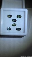 Six oval sapphires in display box, mixed green and blue