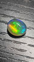 Top view showing multicolour play-of-colour in cabochon