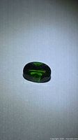 Front view of oval chrome diopside showing color and cut