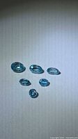 Six blue zircon stones in various oval sizes