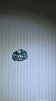 Loose oval blue zircon on neutral background