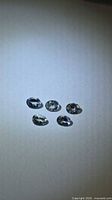 Five oval cut Tanzanite stones on light background