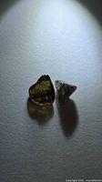 Pair of sapphire crystals under spotlight to show color and shape