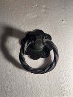 Front view of black cast iron ring pull on scalloped backplate