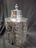 Front view of silver-plated floral jar