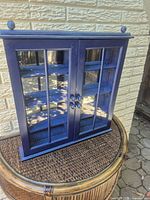 Front view closed doors showing cobalt blue finish, glass panels