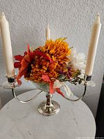 Front view showing three arms, candle sockets, cut glass bowl