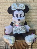 Full view of Minnie Mouse plush seated on chair